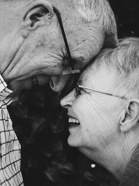 Happy older couple smiling at each other